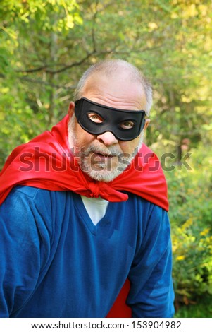 Out of breath senior super hero with red cape