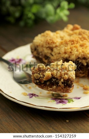 Delicious date square in a nice plate with a bite ready to eat