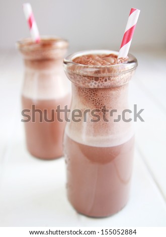 Chocolate milk in a bottle with red ribbon and red straw