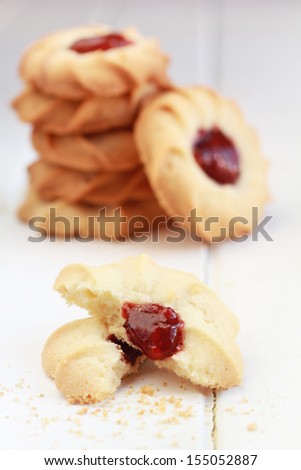Butter cookies and a stack of cookies with strawberry jam