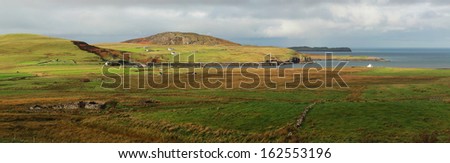 Green panorama with white little house on skye island, Scotland, UK.