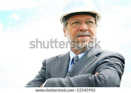 Senior business man with white hard hat