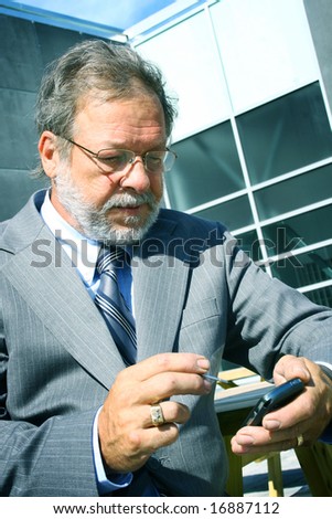 Senior business man sending a message text