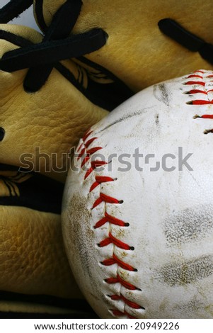 Close up of a softball ball and glove