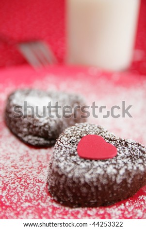 Chocolate heart cake with red heart on top