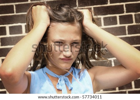 Teenager girl looking very angry and having hand in hair
