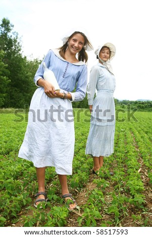 Milk woman in a field with a glass bottle of milk in hand