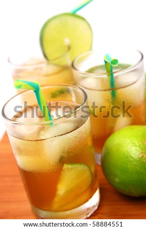 Three Glasses with ice tea and green lemon