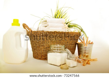 Fresh white towels with liquid soap, powder and clothespins for the laundry day