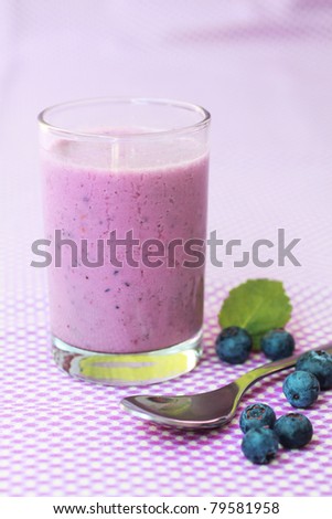 Fresh blueberry smoothie with fresh fruits on a lilac background