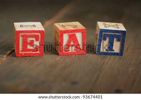 alphabet wood blocks forming the word eat