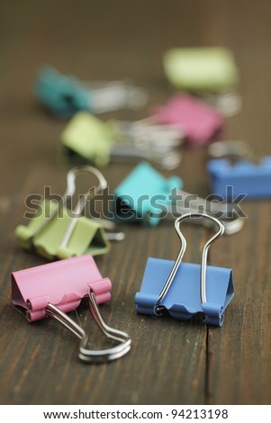 Pastel paper clips on a wooden table