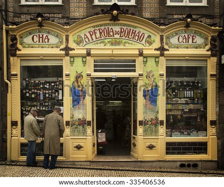 PORTO-PORTUGAL NOVEMBER 4, 2015: Two old men looking a window in a little cafe and store in Porto, Portugal