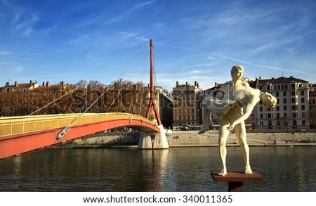 LYON-FRANCE NOVEMBER 14, 2015: The Weight of Oneself created by Elmgreen and Dragset representing a man carrying his double. Inaugurated on sept 2th 2013 next to the passerelle du palais de justice