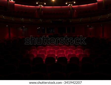 Follow spot on red velvet seat in a generic theater or movie cinema theater