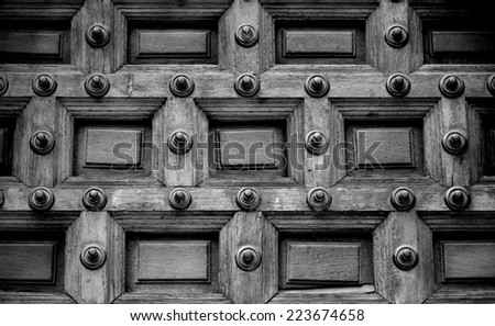 Close up of an Antique door allowing Access to an Ancient Church in Black and White