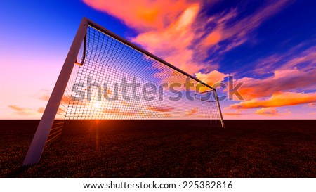 Soccer goal on the football field at sunset.