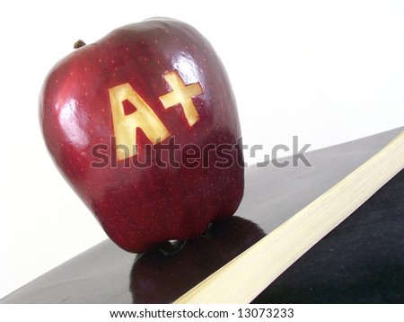Apple with an A plus carved symbolizing good grades or success