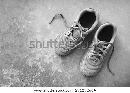 Soccer shoes on wooden floor dirty (Black and white)