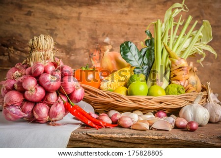 Still life of mix vegetable arranged with basket and white fabrics place on old wooden