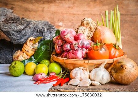 Still life of mix vegetable arranged with basket and white fabrics and logs place on old wooden