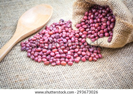 red beans in sack bags with spoon on sack cloth