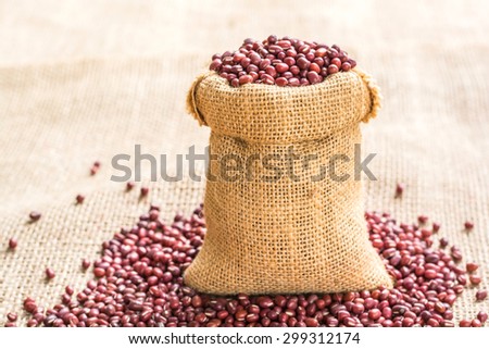 red beans in sack bags with pile of red beans on a sackcloth