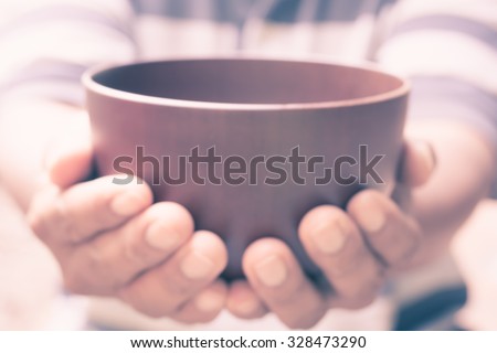 vintage blur of a hungry man holding an empty bowl
