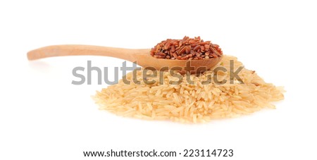 Red rice in a wooden spoon and pile of brown rice isolated on white background
