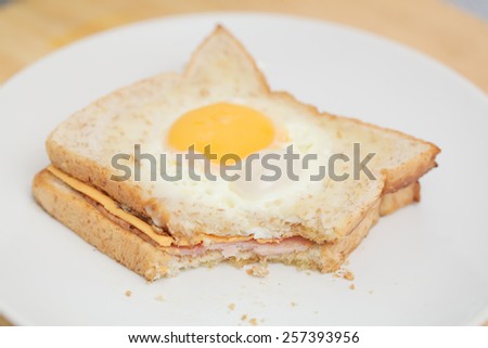 fried egg in hole toast on white plate