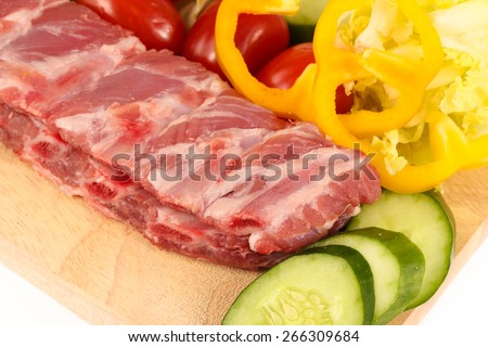 pork ribs on cutting board with vegetable