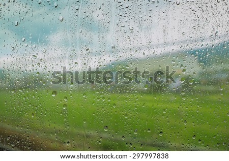in raining day. A view of road and rural area from window
