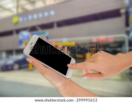 Businesswoman using her smart phone in working environment