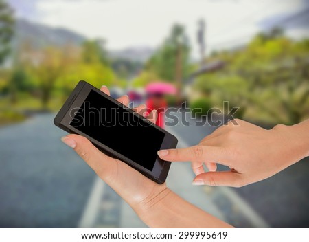 Businessman using smart phone against tree green background
