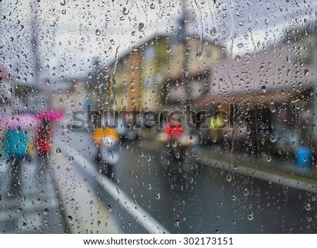 Water drops on a window glass after the rain. View of Buildings in the city.