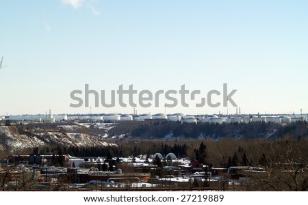 Storage tanks for petrochemical products and sewage (foreground) on the banks for the North Saskatchewan River valley, Edmonton, Alberta