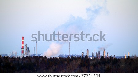 Vapor and gas by-products rise above the valley of the North Saskatchewan River at sunset (East of Edmonton, Alberta)