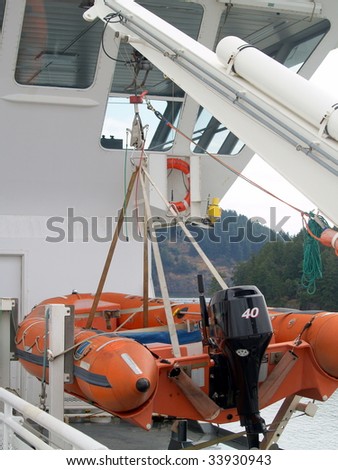 Inflatable rescue and service boat suspended from a dual point davit used for deployment from a ferry boat