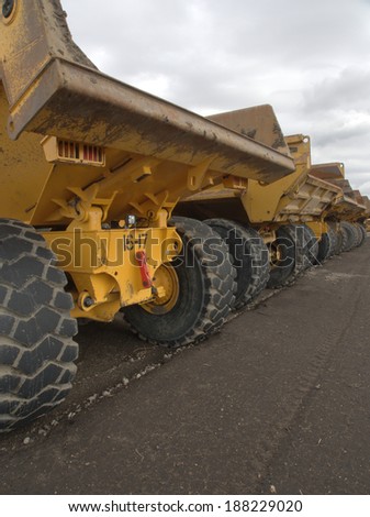 Large off road dump trucks lined up awaiting their next assignment