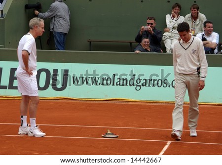 PARIS - JUNE 1: Retired tennis legend John McEnroe is angry against the referee and throws his racket while playing tennis at the Roland Garros Open on June 1, 2008 in Paris, France.