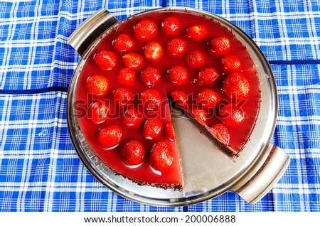 Strawberry cake with jelly and cocoa on a silver platter