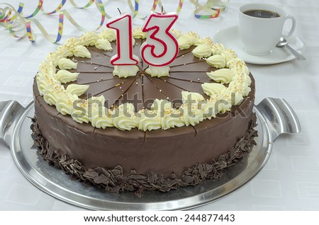 Creamy chocolate birthday cake with numeral thirteen