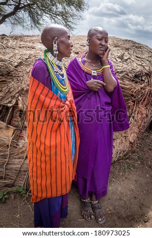 NGORONGORO,TANZANIA - DEC 29, 2013: Masai women talk with happiness before sing the welcome song for tourists who visit Masai village