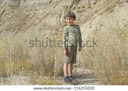Curious happy young boy hikes in the bad lands in Dinosaur Provincial Park