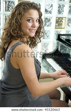Talented and beautiful piano player shallow depth of field