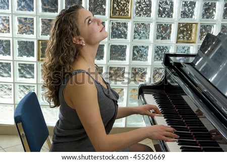 Talented and beautiful piano player shallow depth of field