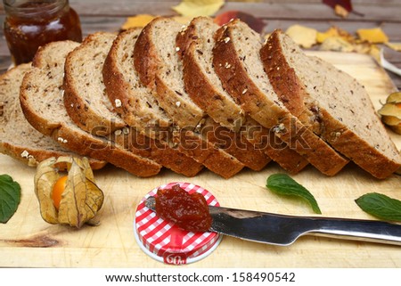 Rustic breakfast with bread, apple jam and Chinese lantern fruit