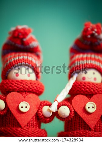 Red woolen hand-made Valentine love couple in a close-up view with nobody