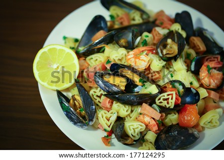 Heart shaped pasta with mussels, shrimps and cherry tomatoes