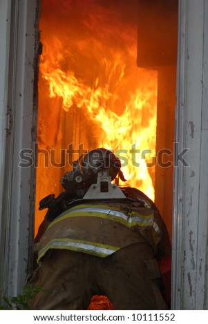 firefighter crawls into burning house